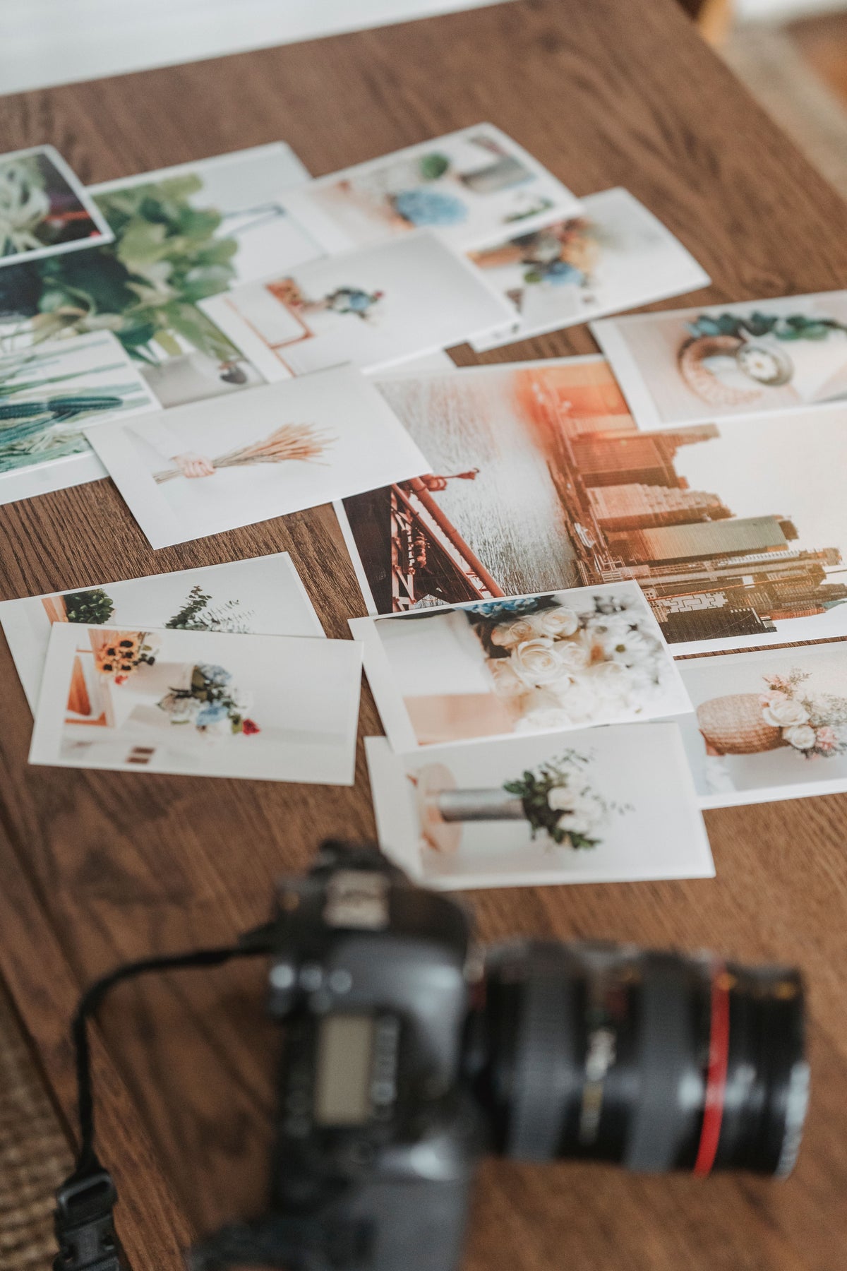 Sample printed photographs arranged on a table — photo by George Milton